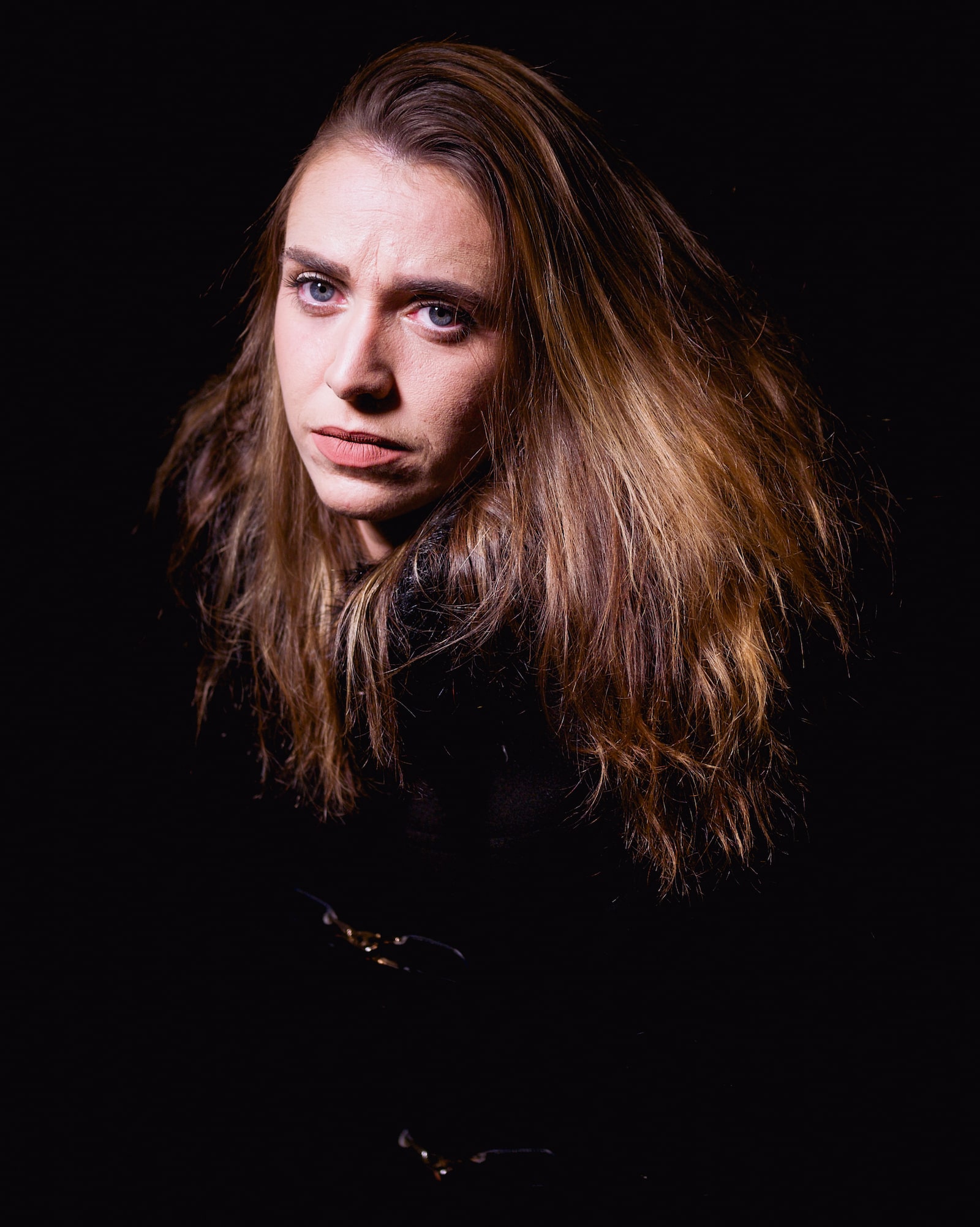 A portrait of a lady on a dark background.